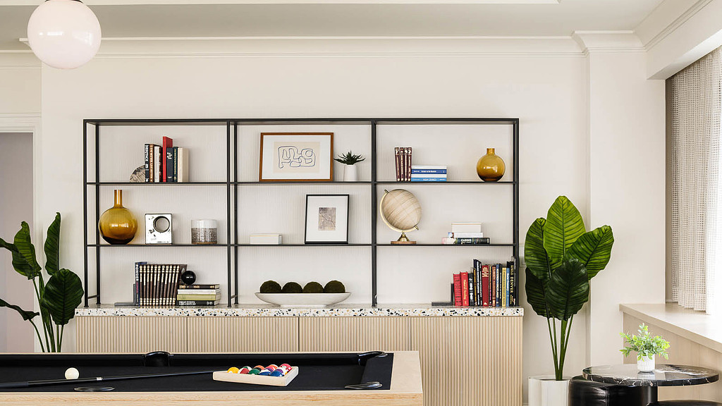 A room with a shelf and a rug and a rug.
